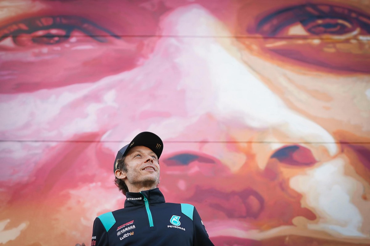 Валентино Росси на фоне огромной картины на стене здания Ricardo Tormo Circuit